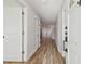 Bright hallway with wood-look tile and white doors leading to various rooms at 206 N Beverly Ave # 1/2, Tampa, FL 33609