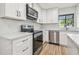 Updated kitchen featuring stainless steel appliances, white cabinets, and neutral countertop at 206 N Beverly Ave # 1/2, Tampa, FL 33609