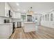 Spacious kitchen with white cabinetry, island, stainless appliances, and backyard view at 206 N Beverly Ave # 1/2, Tampa, FL 33609