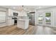 Modern white kitchen with stainless steel appliances, island, shaker cabinets, and backyard access at 206 N Beverly Ave # 1/2, Tampa, FL 33609