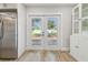 Bright kitchen area featuring stainless steel refrigerator and glass paneled door to the outside deck at 206 N Beverly Ave # 1/2, Tampa, FL 33609