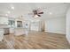 Open concept living room and kitchen with stainless steel appliances and wood floors at 206 N Beverly Ave # 1/2, Tampa, FL 33609