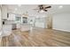 Open concept living room and kitchen with stainless steel appliances and wood floors at 206 N Beverly Ave # 1/2, Tampa, FL 33609