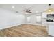 Bright living space featuring wood-look tile, ceiling fan, neutral paint, and seamless flow to the kitchen at 206 N Beverly Ave # 1/2, Tampa, FL 33609