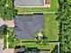 Aerial view of a home showcasing its roof, backyard with mature trees, and location within the neighborhood at 20835 Lake Talia Blvd, Land O Lakes, FL 34638