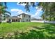 Expansive backyard featuring lush green grass and a full privacy fence at 20835 Lake Talia Blvd, Land O Lakes, FL 34638