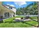Large backyard with a patio, fire pit, swing, and a privacy fence, perfect for outdoor living and entertaining at 20835 Lake Talia Blvd, Land O Lakes, FL 34638