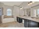 Bathroom featuring double sinks, a soaking tub, a separate shower, and tile flooring at 20835 Lake Talia Blvd, Land O Lakes, FL 34638