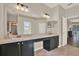 Bathroom with tile floor, double sinks, large mirror, and a door to the outside at 20835 Lake Talia Blvd, Land O Lakes, FL 34638