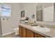 Charming bathroom featuring a framed window, vanity with drawers and a toilet at 20835 Lake Talia Blvd, Land O Lakes, FL 34638