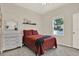 Comfortable bedroom with carpet floors, a double bed, dresser and a bright window with natural lighting at 20835 Lake Talia Blvd, Land O Lakes, FL 34638