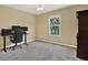 This bedroom features neutral walls, gray carpet, and a window that provides natural light at 20835 Lake Talia Blvd, Land O Lakes, FL 34638