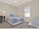 Bright bedroom featuring carpet, a window, a double bed with books and a dresser at 20835 Lake Talia Blvd, Land O Lakes, FL 34638