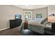Bedroom with wood floors, neutral walls, and a bed with an iron frame and a gingham comforter at 20835 Lake Talia Blvd, Land O Lakes, FL 34638