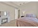 Cozy bedroom featuring carpet, a window, a desk with vanity and a comfortable bed with pillows at 20835 Lake Talia Blvd, Land O Lakes, FL 34638