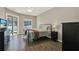 Cozy bedroom with hardwood floors, a ceiling fan, a door to backyard, and ample natural light at 20835 Lake Talia Blvd, Land O Lakes, FL 34638