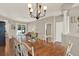 Bright dining area with wood table, stylish chandelier, and natural light from the sliding glass doors at 20835 Lake Talia Blvd, Land O Lakes, FL 34638