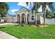 Well-maintained home with a landscaped front yard and a three-car garage at 20835 Lake Talia Blvd, Land O Lakes, FL 34638