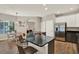 The kitchen features a large black granite island, stainless steel refrigerator, and light-colored cabinets at 20835 Lake Talia Blvd, Land O Lakes, FL 34638