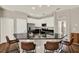 Bright kitchen with stainless steel appliances, white cabinets, black granite island, and bar stool seating at 20835 Lake Talia Blvd, Land O Lakes, FL 34638