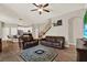 Bright living room featuring leather sofas, hardwood floors, staircase, and access to the kitchen at 20835 Lake Talia Blvd, Land O Lakes, FL 34638