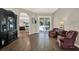 Living room with hardwood floors, a large black cabinet, and archway to another room at 20835 Lake Talia Blvd, Land O Lakes, FL 34638