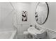 Classic bathroom featuring white subway tile, a pedestal sink and black and white floors at 217 W Powhatan Ave, Tampa, FL 33604
