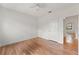 Bright bedroom features hardwood floors, ceiling fan, and freshly painted walls at 217 W Powhatan Ave, Tampa, FL 33604
