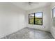 Bright bedroom features modern floors and a window overlooking lush greenery at 217 W Powhatan Ave, Tampa, FL 33604