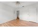 Neutral bedroom features wood floors, a ceiling fan, and freshly painted walls at 217 W Powhatan Ave, Tampa, FL 33604