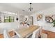 Dining area featuring a wooden table, four chairs, a view to the living area and hardwood floors at 217 W Powhatan Ave, Tampa, FL 33604