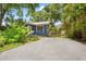 Charming home with well-maintained lawn, driveway, and mature trees providing shade at 217 W Powhatan Ave, Tampa, FL 33604