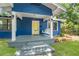 Inviting front porch featuring a classic swing and stylish design elements at 217 W Powhatan Ave, Tampa, FL 33604