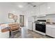 Cozy kitchen featuring an eat-in bench, colorful floors and white appliances at 217 W Powhatan Ave, Tampa, FL 33604