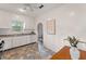 Charming kitchen with white cabinets, a view to the dining area and a tiled floor at 217 W Powhatan Ave, Tampa, FL 33604