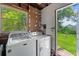 Laundry room features a washer and dryer, and a view to the backyard at 217 W Powhatan Ave, Tampa, FL 33604