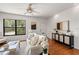 Well-lit living room with hardwood floors, neutral decor, and a large window at 217 W Powhatan Ave, Tampa, FL 33604