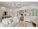 Comfortable living room with hardwood floors, neutral decor and a view to the dining area at 217 W Powhatan Ave, Tampa, FL 33604