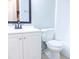 A white vanity and toilet with a dark-framed mirror at 220 Berry Tree Pl # 220, Brandon, FL 33510