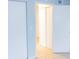 An open doorway reveals the freshly painted walls and tiled floor in this hallway at 220 Berry Tree Pl # 220, Brandon, FL 33510