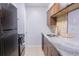 Modern kitchen features stainless steel sink, granite countertop, and black appliances at 220 Berry Tree Pl # 220, Brandon, FL 33510
