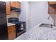 Modern kitchen features stainless steel sink, granite countertop, and black appliances at 220 Berry Tree Pl # 220, Brandon, FL 33510