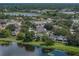 Beautiful aerial view of lakefront property with mature trees and easy access to the highway at 22829 Saint Thomas Cir, Lutz, FL 33549