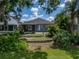 Landscaped backyard with well-manicured lawn and lovely greenery at 22829 Saint Thomas Cir, Lutz, FL 33549