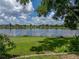 Beautiful lake view from the backyard with a boat docked on the manicured lawn at 22829 Saint Thomas Cir, Lutz, FL 33549