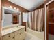 Bathroom with shower-tub combination, vanity, and traditional finishes at 22829 Saint Thomas Cir, Lutz, FL 33549