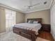 Cozy bedroom featuring wood floors, soft carpet, and a stylish bed at 22829 Saint Thomas Cir, Lutz, FL 33549
