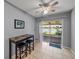 Dining area with breakfast table, bar stools, and sliding glass doors leading to the patio at 22829 Saint Thomas Cir, Lutz, FL 33549
