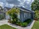 Beautifully landscaped single-Gathering home with a two-car garage and lush tropical plants near the entrance at 22829 Saint Thomas Cir, Lutz, FL 33549