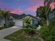 Charming single-Gathering home with a well-manicured lawn, mature palm trees, and a two-car garage at 22829 Saint Thomas Cir, Lutz, FL 33549